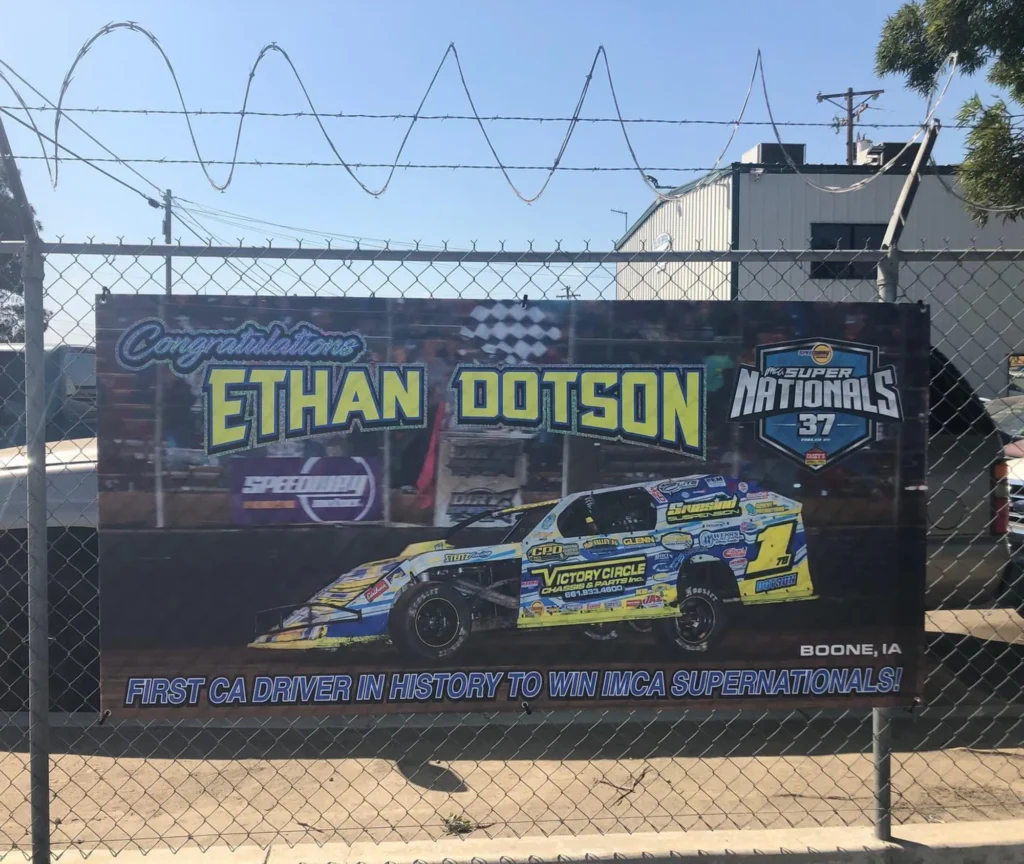 Banner congratulating Ethan Dotson for winning IMCA Super Nationals, featuring a race car and text highlighting his achievement as the first California driver to win.