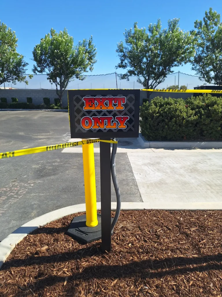 Custom illuminated Exit Only directional parking lot sign with Salty's BBQ branding in Bakersfield, CA