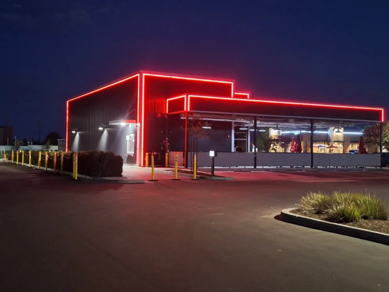 Red LED outline accent lighting tracing the roofline of Salty's BBQ & Catering at night in Bakersfield, CA